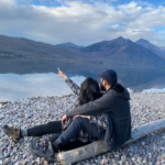 cute travel blogger couple posing at lake mcdonald glaciar national park